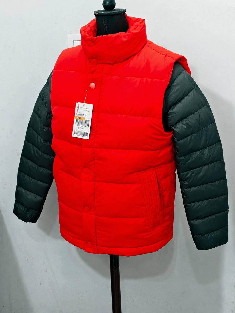 Raw supplier photo of the jacket on a mannequin with a price tag